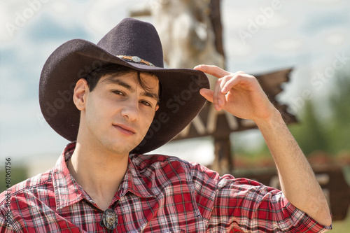 Photo: Cowboy on sign background. Cowboy on sign background.