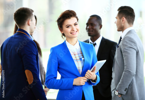 Photo: beautiful businesswoman on the background of business people beautiful businesswoman on the background of business people