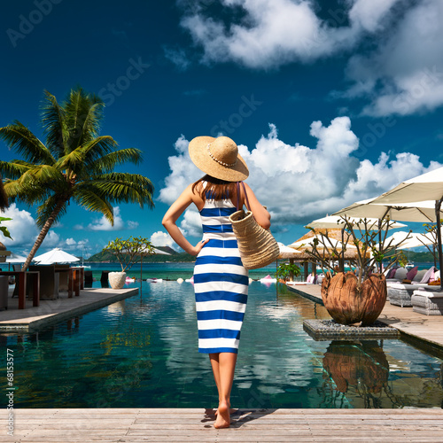 Photo: Woman sailor striped in dress near poolside Woman sailor striped in dress near poolside
