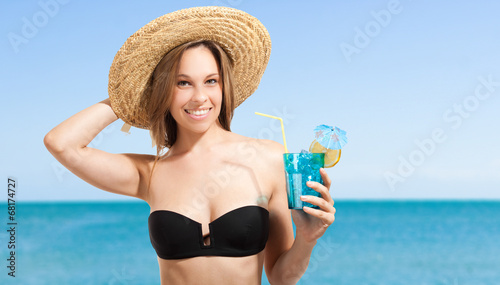 Photo: Woman in bikini having a drink Woman in bikini having a drink