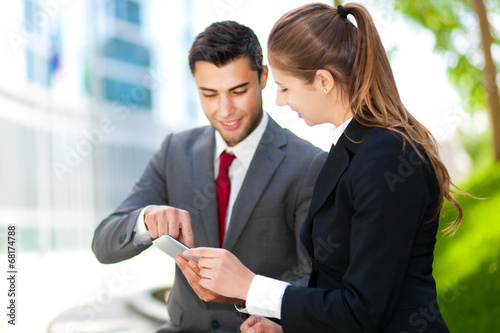 Photo: Business people using a digital tablet Business people using a digital tablet