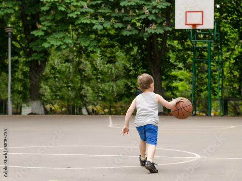 Photo: Young boy playing basketball Young boy playing basketball