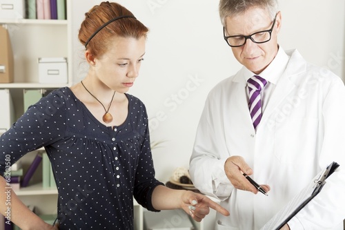 Photo: Doctor with young female patient woman Doctor with young female patient woman