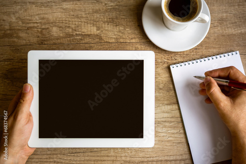 Photo: workplace with digital tablet, notebook and coffee cup workplace with digital tablet, notebook and coffee cup