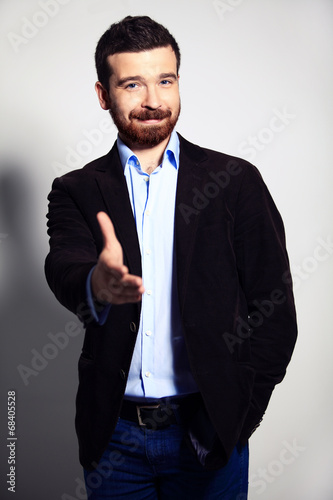 Photo: A business man with an open hand ready to seal a deal A business man with an open hand ready to seal a deal