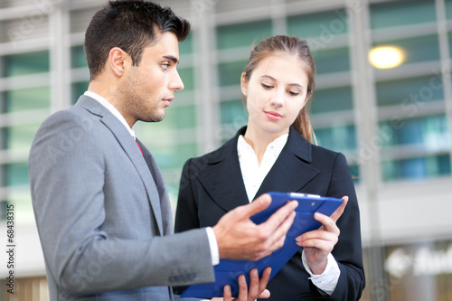 Photo: Two business people outdoor Two business people outdoor