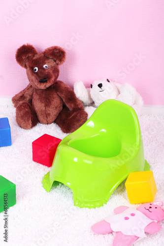 Photo: Green potty on home interior background Green potty on home interior background