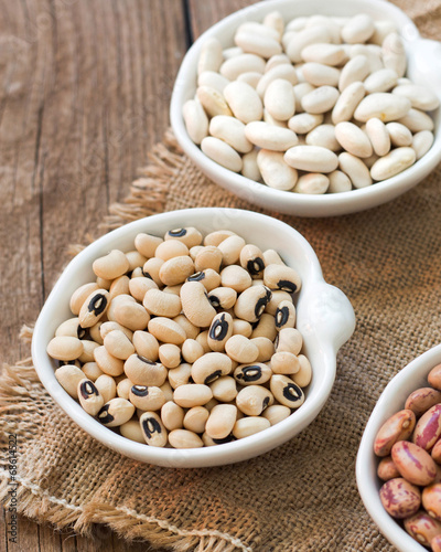 Photo: Assortment of legumes in bowls on wooden table Assortment of legumes in bowls on wooden table