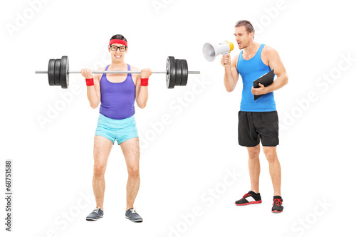 Photo: Fitness coach shouting at a guy through megaphone Fitness coach shouting at a guy through megaphone