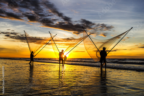 Photo: Fishermen fishing in the sea at sunrise Fishermen fishing in the sea at sunrise
