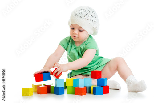 Photo: child playing toy blocks isolated on white background child playing toy blocks isolated on white background