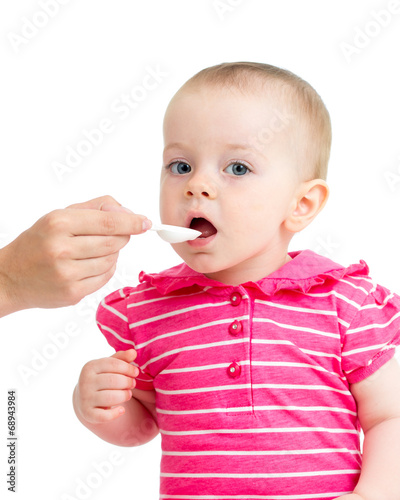 Photo: doctor giving remedy feeding with a spoon doctor giving remedy feeding with a spoon