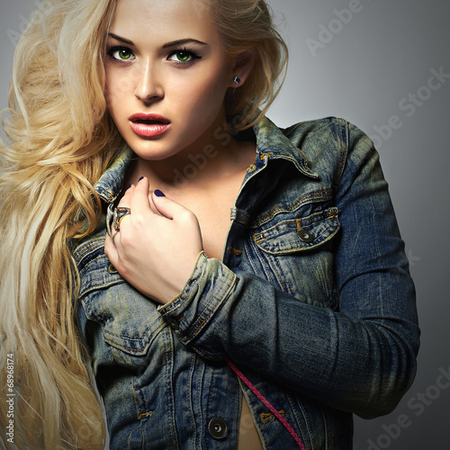 Photo: fashionable beautiful girl in jeans.blond Sexy woman.Long hair fashionable beautiful girl in jeans.blond Sexy woman.Long hair