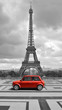 Eiffel tower with car. Black and white photo with red element. Eiffel tower with car. Black and white photo with red element.