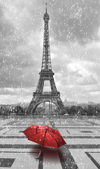 Eiffel tower in the rain. Black and white photo with red element