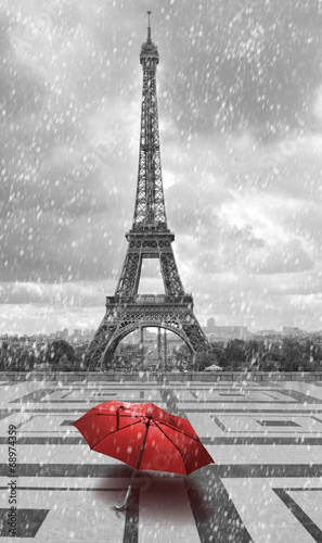 Eiffel tower in the rain. Black and white photo with red element