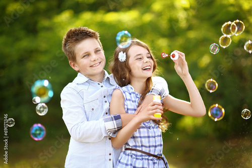 Photo: Portrait of a boy girl in a summer with bubble Portrait of a boy girl in a summer with bubble