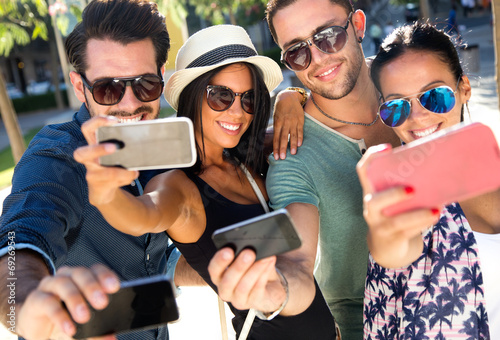Photo: Portrait of group friends taking photos with a smartphone. Portrait of group friends taking photos with a smartphone.
