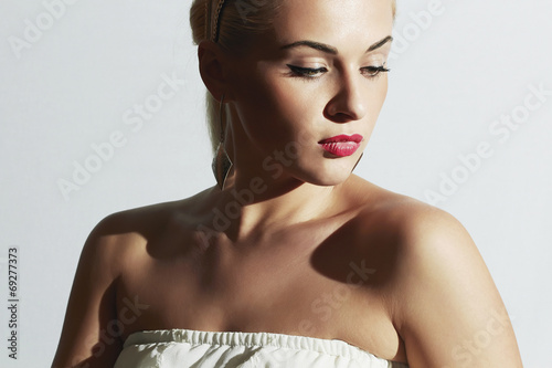 Photo: Beautiful woman in white dress.Fashion Pretty girl with red lips Beautiful woman in white dress.Fashion Pretty girl with red lips