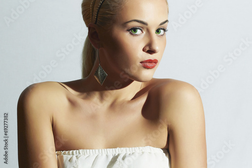 Photo: Beautiful woman in white dress.Fashion blond girl with red lips Beautiful woman in white dress.Fashion blond girl with red lips