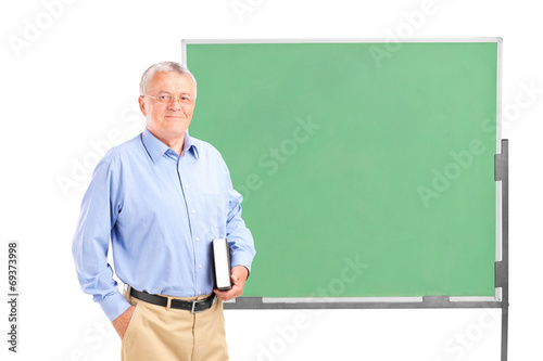 Photo: Mature school teacher holding a book Mature school teacher holding a book