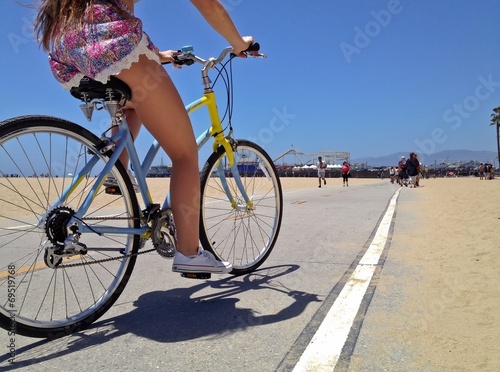 Instant Collection: Pretty Woman riding a bicycle along Santa Monica Beach pathway Pretty Woman riding a bicycle along Santa Monica Beach pathway