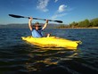 Athletic man kayaking on Lake Tahoe with dog. Athletic man kayaking on Lake Tahoe with dog.