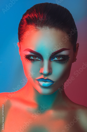 Obraz w ramie Glamour adult brunette with make up in red and blue lights