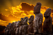 Standing moais with orange clouds in background in Easter Island Standing moais with orange clouds in background in Easter Island