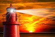 Red Lighthouse with Light Beam at Sunset Red Lighthouse with Light Beam at Sunset