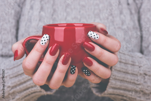 Woman with manicured nails holding a cup © tamara83
