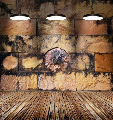 colorful stained lion stone and old brick wall on wooden floor