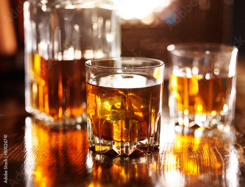 two glasses of whiskey with decanter