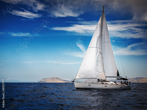 The white sails of yachts on the background of sea