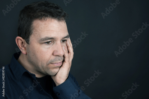 Sad man with hand in face - 82859746