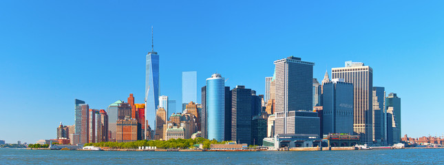 New York City lower Manhattan financial  wall street district buildings skyline on a beautiful summer day with blue sky