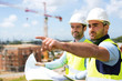 Worker and architect watching some details on a construction Worker and architect watching some details on a construction