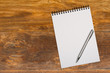 Blank notepad with pen on office wooden table Blank notepad with pen on office wooden table
