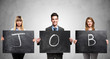 People holding blackboards with the word Job written on People holding blackboards with the word Job written on