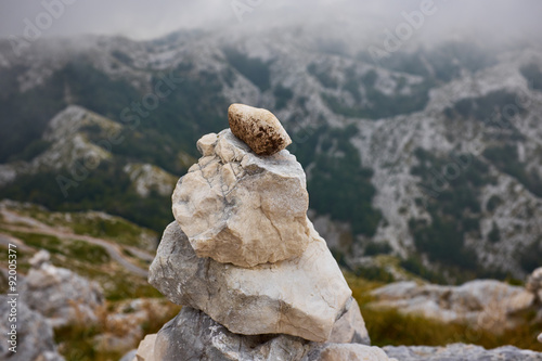 stacked stones on a background of mountains