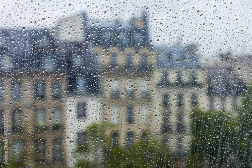 PARIS, FRANCE, on AUGUST 27, 2015. A fragment of skyline of the square in front of the Centre Georges Pompidou, a look through a wet window. It is raining, water drops on glass, focus on drops Photo by Elena Belyaeva