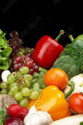 Group of different vegetables and fruits on black