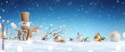 Snowman With Baubles On Snow
