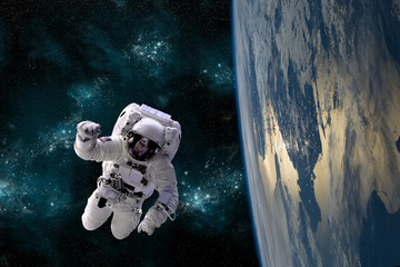 An astronaut floats in the zero gravity environment of space - Elements of this image furnished by NASA.