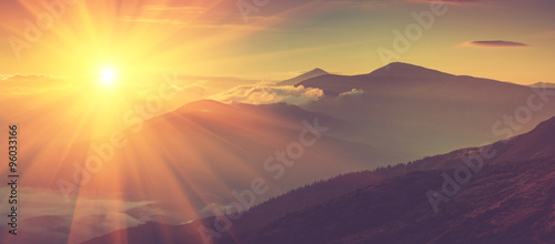 Panoramic view of mountains, autumn landscape with foggy hills at sunrise.