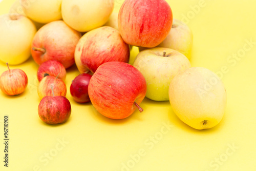 ripe apples on a yellow background