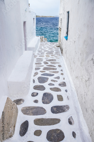  Traditional whitewashed alley of Mykonos with seaview, Greece