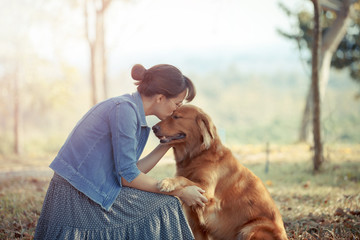 Beautiful woman with a cute golden retriever dog