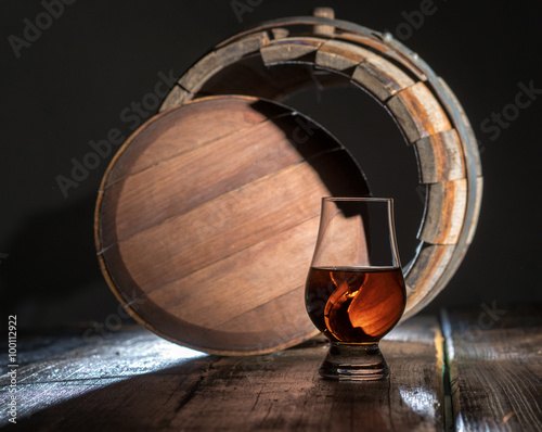 A glass of calvados on an oak barrel