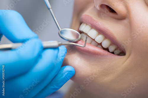 Dentist examining a patient's teeth in the dentist. © Andriy Bezuglov
